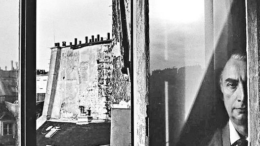 Roland Barthes peers out a Paris window