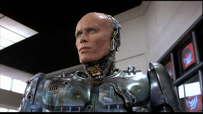 a picture of Robocop, where his face is shown cybernetically grafter on to a metal body